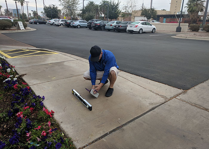 Two Life Quest team members measuring the slope of the accessible route