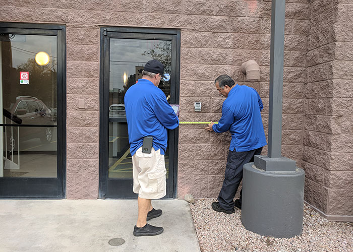 Two Life Quest team members measuring entrance maneuvering clearance