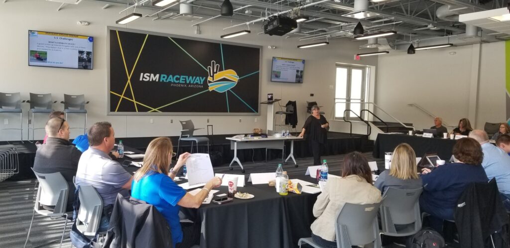 Dr. Nanette Odell leading a presentation for a small group of people at ISM Raceway.